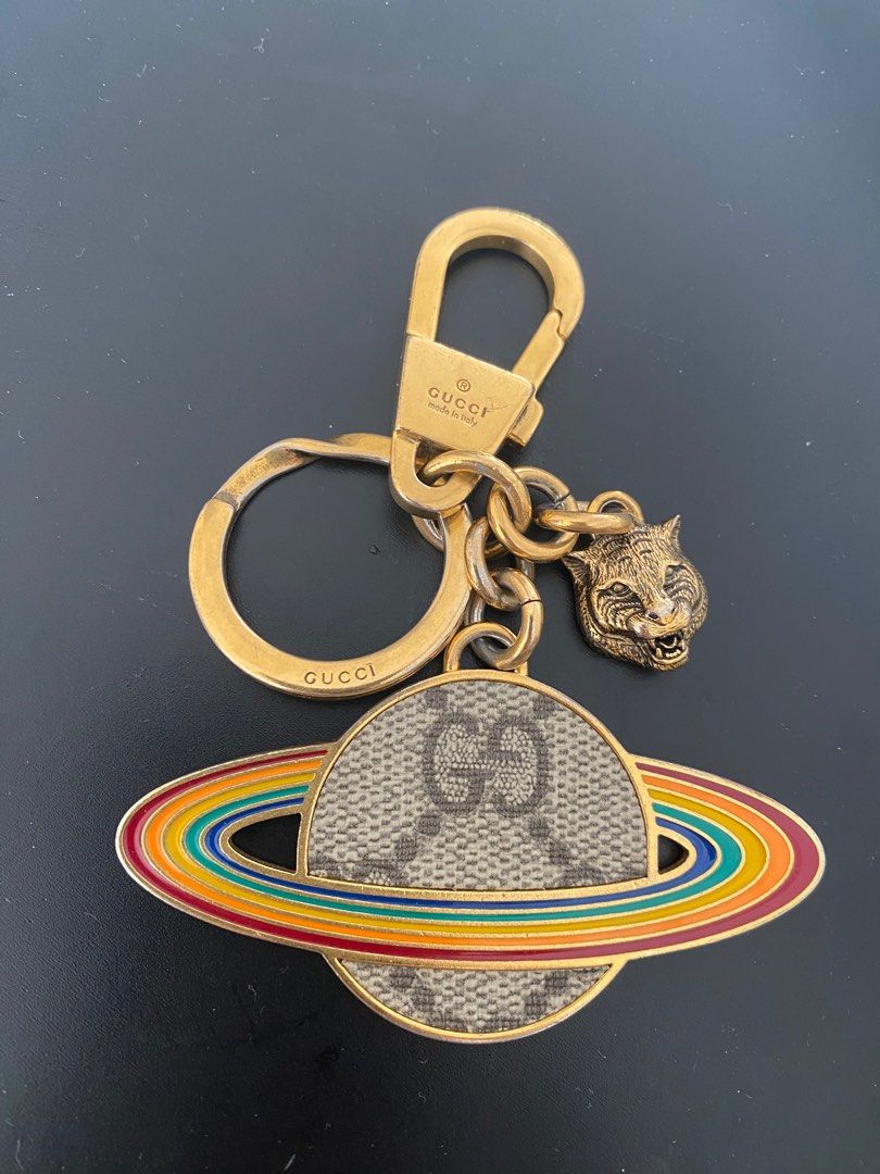 Gucci Planet Rainbow Supreme Keychain (Category: Accessories) located in Singapore. Submitted by mytokyo (Listing ID 1231386139, Image 2). Description: Gucci Planet GG Rainbow Supreme keyring Keychain Rare and exquisite! Statement piece Gucci’s yellow-goldtone brass GG Supreme Planet key chain features the house’s signature feline-head emblem and a flat charm sculpted into the shape of the planet Saturn. The planet is embellished with a beige and