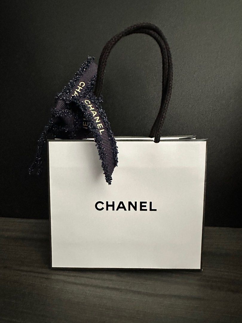 Chanel Gift Bag with Christmas Ribbon (Category: Accessories) located in Singapore. Submitted by absolutcode (Listing ID 1402117903, Image 3). Description: - Authentic Chanel gift bag - Size length 14cm x height 12cm x width 5cm - Includes original ribbon - Ideal for gifting or collecting - A stylish accessory Self collection from my place preferred SingPost Tracked Mailing available at $2.