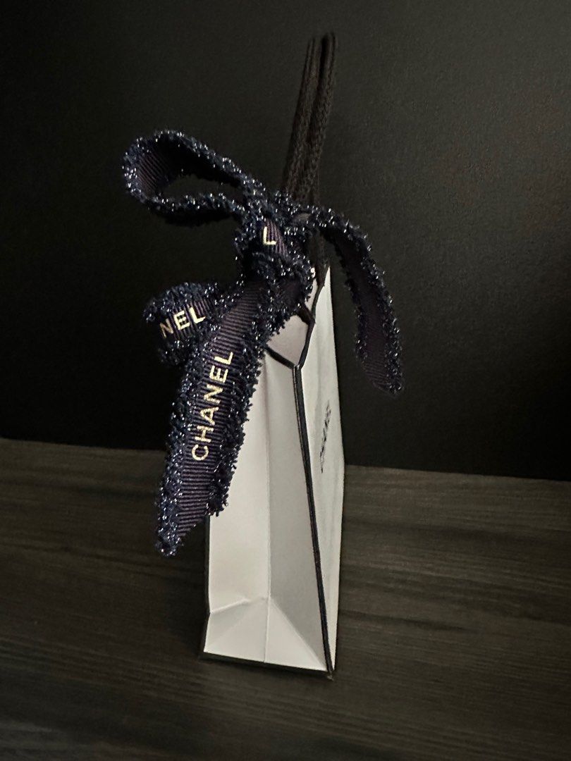 Chanel Gift Bag with Christmas Ribbon (Category: Accessories) located in Singapore. Submitted by absolutcode (Listing ID 1402117903, Image 2). Description: - Authentic Chanel gift bag - Size length 14cm x height 12cm x width 5cm - Includes original ribbon - Ideal for gifting or collecting - A stylish accessory Self collection from my place preferred SingPost Tracked Mailing available at $2.