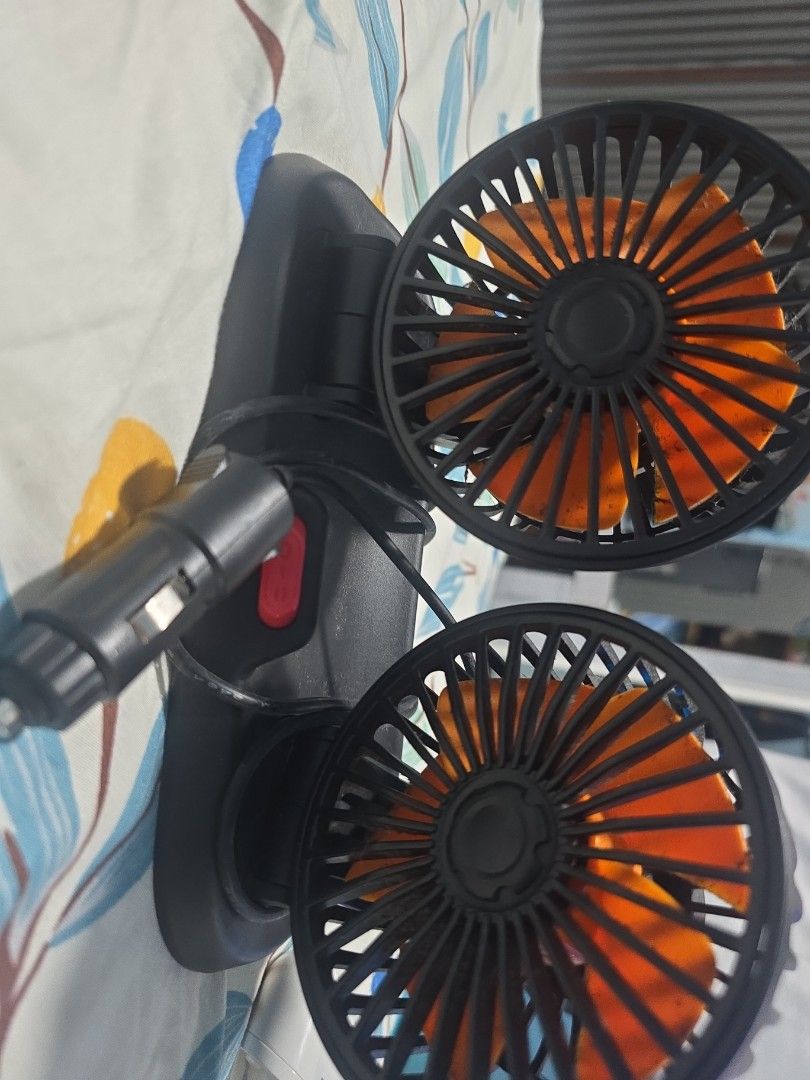 Dual Head Car Fan (Category: Other Electronics) located in Singapore. Submitted by isha75 (Listing ID 1410873383, Image 1). Description: - Dual-head car fan - Orange fan blades - Plugs into car cigarette lighter - Features a red power button - Keeps you cool in the car!.