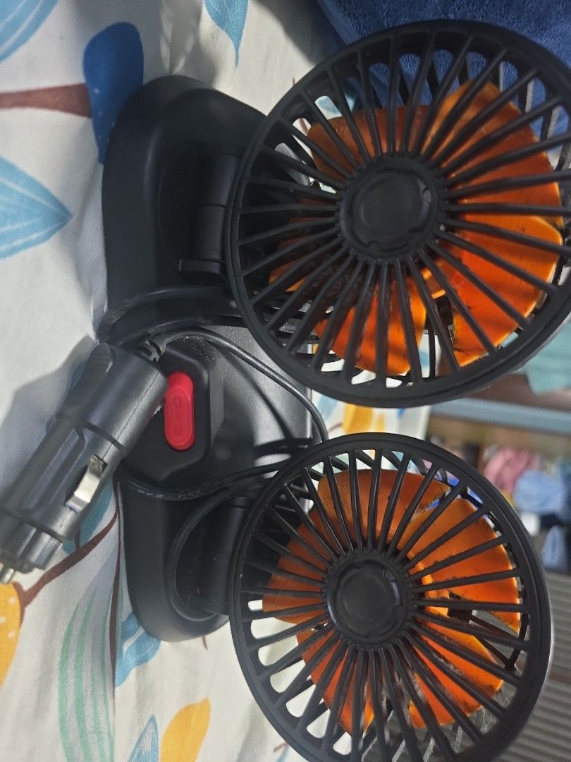 Dual Head Car Fan (Category: Other Electronics) located in Singapore. Submitted by isha75 (Listing ID 1410873383, Image 2). Description: - Dual-head car fan - Orange fan blades - Plugs into car cigarette lighter - Features a red power button - Keeps you cool in the car!.
