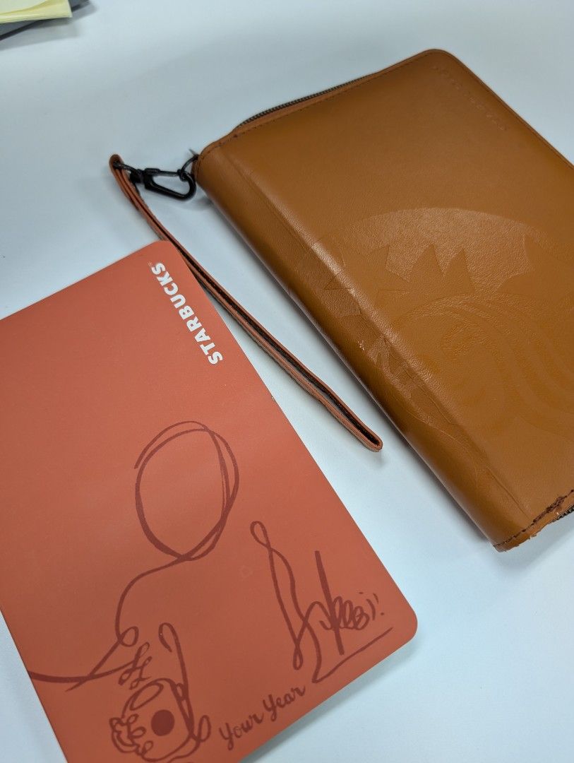 Starbucks Leather Planner & Notebook (Category: Stationery & School Supplies) located in Singapore. Submitted by rainingpups (Listing ID 1375920693, Image 1). Description: Starbucks planner with zipper closure and matching notebook. The planner has an inner pocket and card slots, includes a detachable strap. Notebook has empty pages (blank/grid/dot), calendar is 2019/2020. Planner is not used before but peeled a little inside from storage - see 2