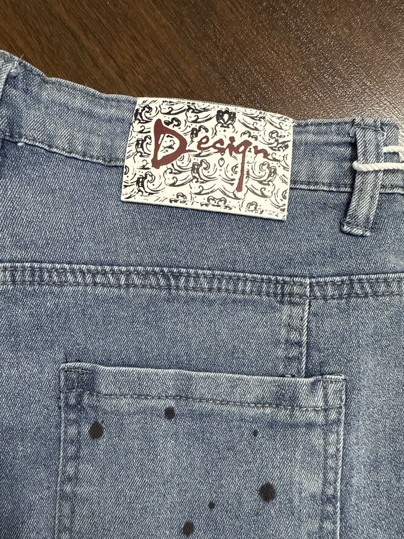 DSQUARED2 Gucci Denim Shorts (Category: Jeans & Leggings) located in Singapore. Submitted by unicorn49 (Listing ID 1391886610, Image 5). Description: - Stylish denim shorts - Features DSQUARED2 tag and Gucci logo patch - Distressed look with paint splatter details - In good condition - Ready to wear.