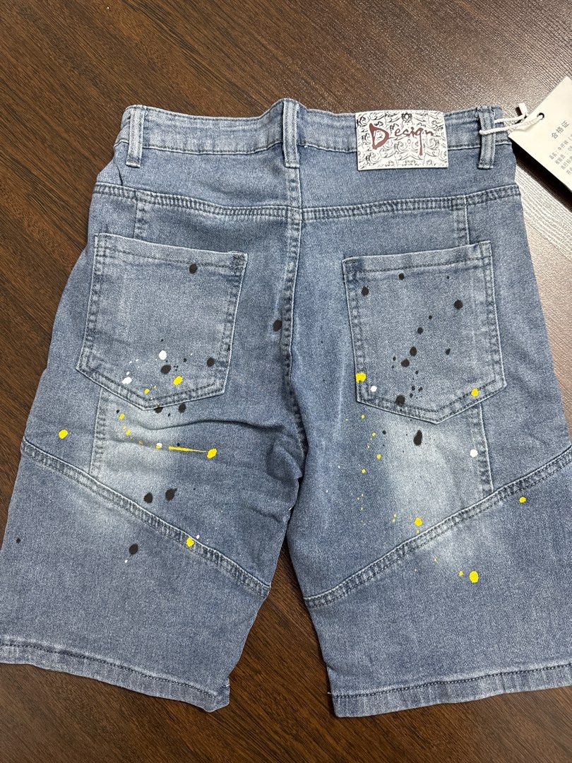 DSQUARED2 Gucci Denim Shorts (Category: Jeans & Leggings) located in Singapore. Submitted by unicorn49 (Listing ID 1391886610, Image 6). Description: - Stylish denim shorts - Features DSQUARED2 tag and Gucci logo patch - Distressed look with paint splatter details - In good condition - Ready to wear.