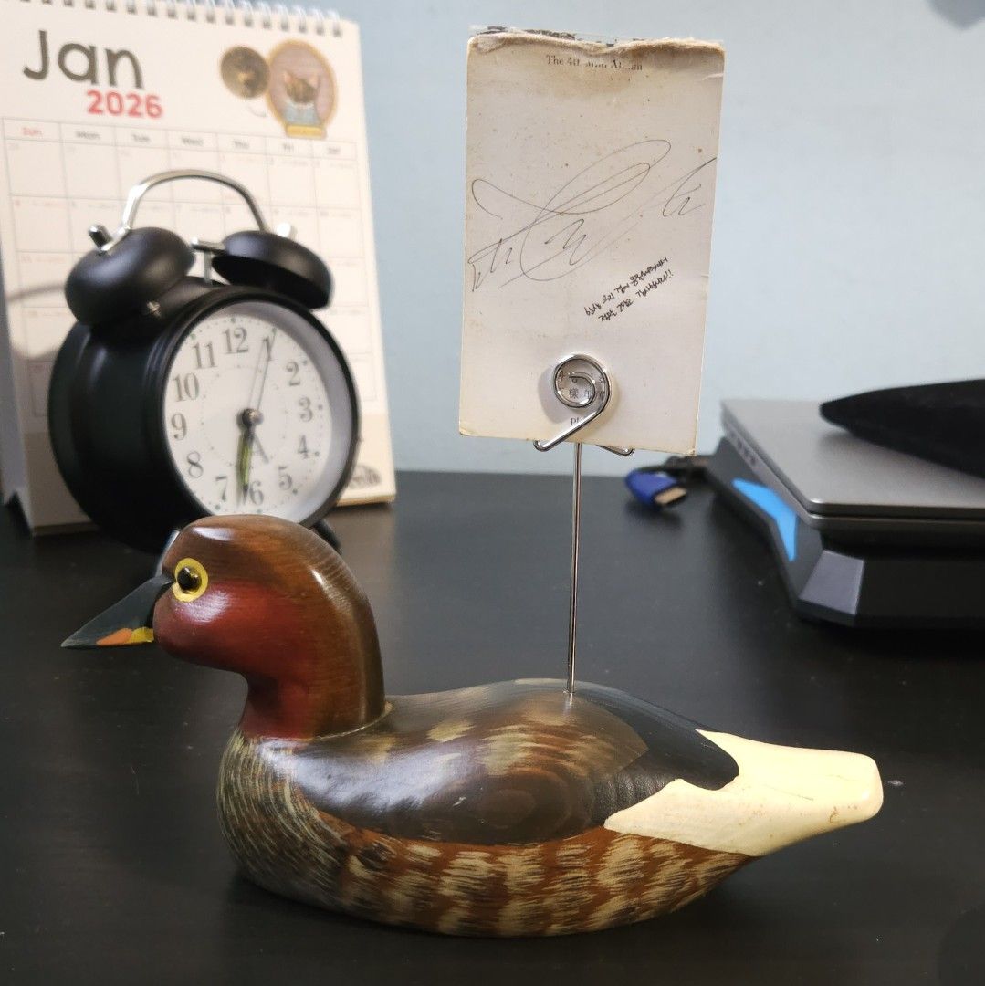 Vintage Hand-Carved Wooden Duck Figurine with Card Holder (Category: Vintage Collectibles) located in Singapore. Submitted by yummiv (Listing ID 1417722689, Image 7). Description: - Vintage hand-carved duck figurine - Intricate hand-painted details - Card holder for photos/notes - Perfect for desk or shelf display.