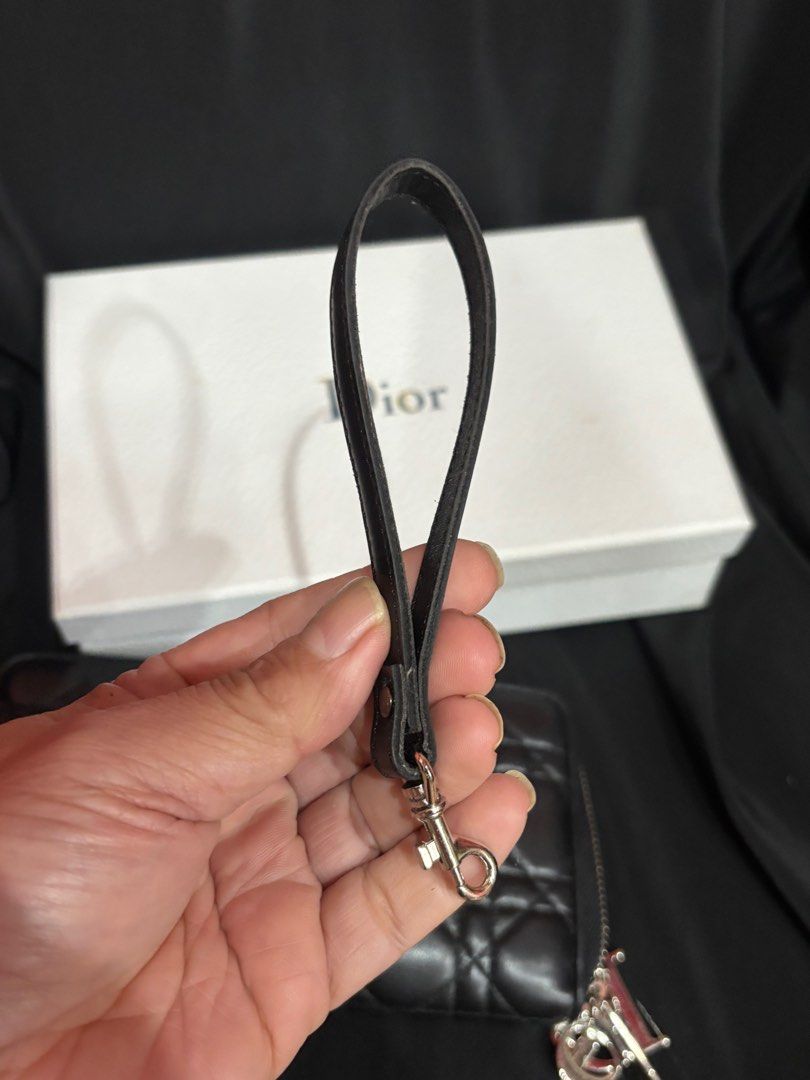 Preloved Athentic Christian Dior Black Cannage Quilted Lambskin Leather Lady Dior Zippy Wallet (Category: Bags & Wallets) located in Singapore. Submitted by villageplace (Listing ID 1413229682, Image 6). Description: This Dior wallet is a stunning addition to your collection. The wallet features the iconic Cannage quilted pattern in a lovely lambskin leather. The hanging DIOR charm letters (which are also removable) in silvertone hardware add som