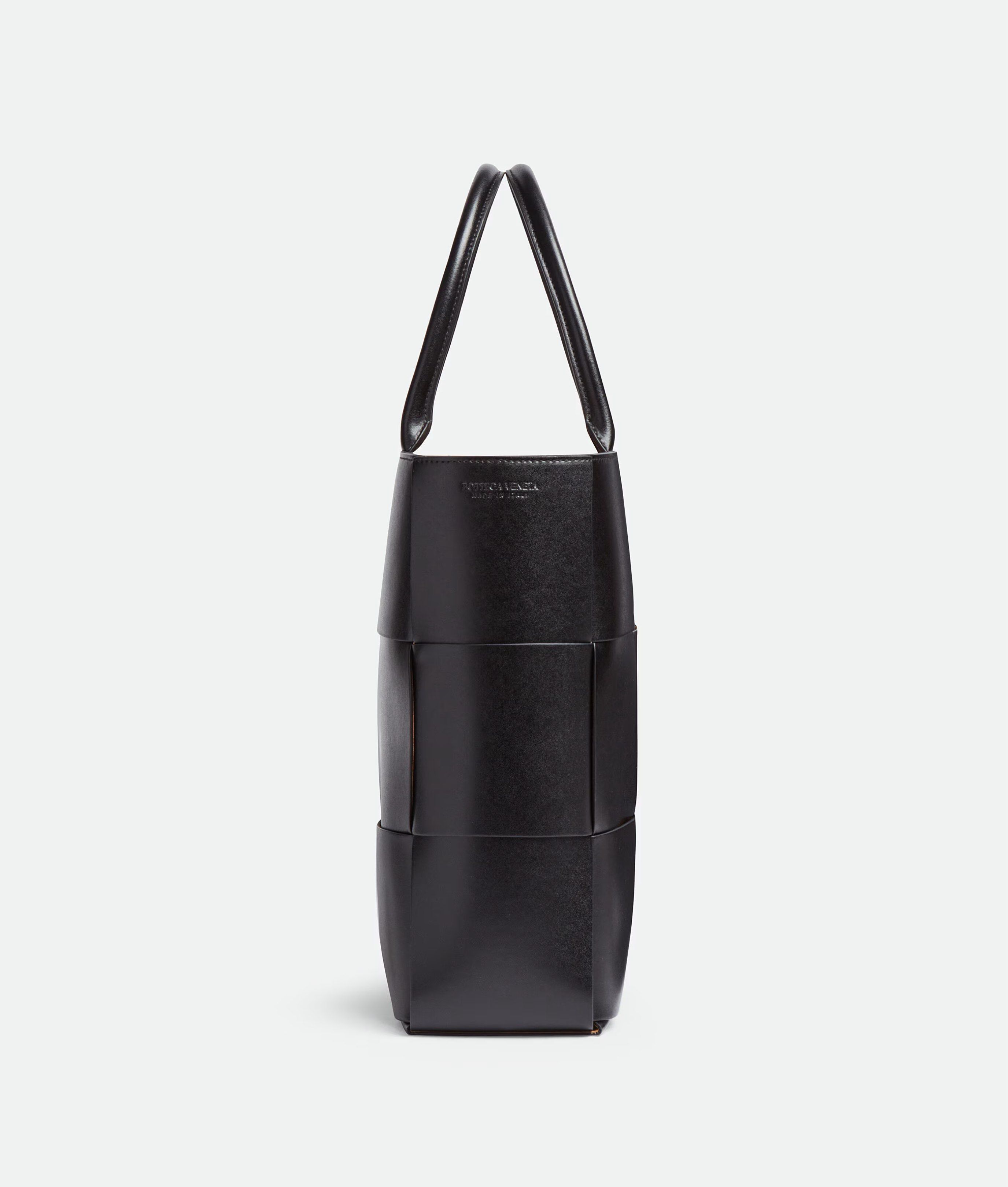 Bottega Veneta Large Arco Tote Bag - Black (Category: Bags & Wallets) located in Singapore. Submitted by magikarpshows (Listing ID 1420557952, Image 3). Description: Large intreccio leather tote bag. • Large intreccio leather tote bag • Single detachable interior zipped pocket • Lining: Bonded suede • Color: Black • Hardware: Silver finish • Made in: Italy Size & fit • Height: 34.5 cm • Width: 46 cm • Depth: 11 cm • Handle drop: 18 cm • Fits a 16