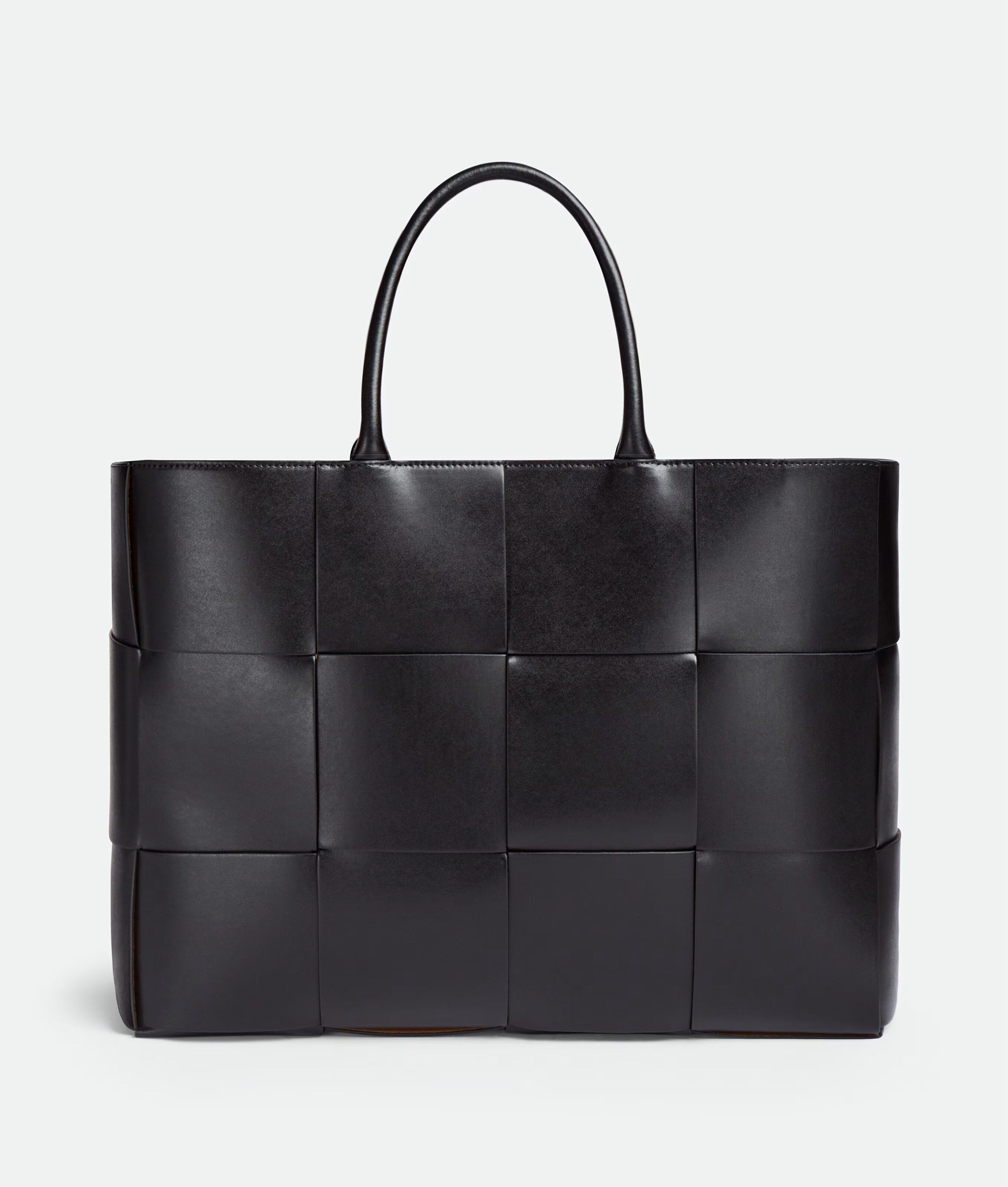 Bottega Veneta Large Arco Tote Bag - Black (Category: Bags & Wallets) located in Singapore. Submitted by magikarpshows (Listing ID 1420557952, Image 1). Description: Large intreccio leather tote bag. • Large intreccio leather tote bag • Single detachable interior zipped pocket • Lining: Bonded suede • Color: Black • Hardware: Silver finish • Made in: Italy Size & fit • Height: 34.5 cm • Width: 46 cm • Depth: 11 cm • Handle drop: 18 cm • Fits a 16