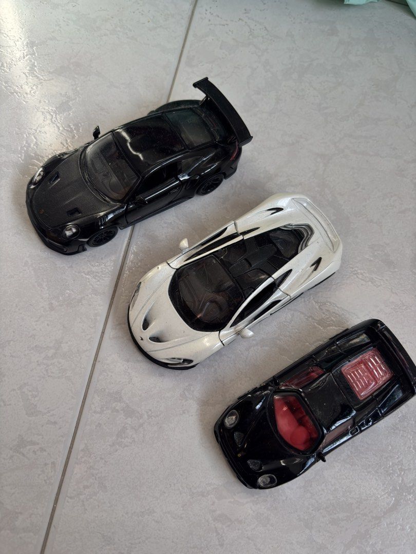 Diecast Toy Cars - Assorted Models (Category: Vehicle & Diecast Models) located in Singapore. Submitted by joelleeeee (Listing ID 1425829535, Image 1). Description: Toy cars. Porsche 911 GT2 rs McLaren p1 Ferrari F50 One for $8 All for $18.