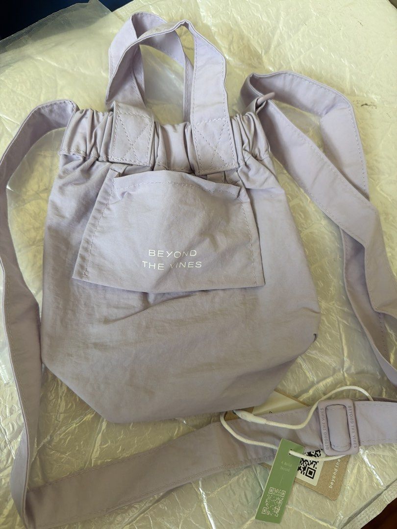 Beyond The Vines Micro Dumpling Bag - Lilac (Category: Cross-body Bags) located in Singapore. Submitted by zoeli_makeup (Listing ID 1430269500, Image 2). Description: Brand new Beyond The Vines Micro Dumpling Bag in a lovely lilac colour. Features a front pocket and adjustable straps. Comes with original tags attached. Perfect for everyday use! .