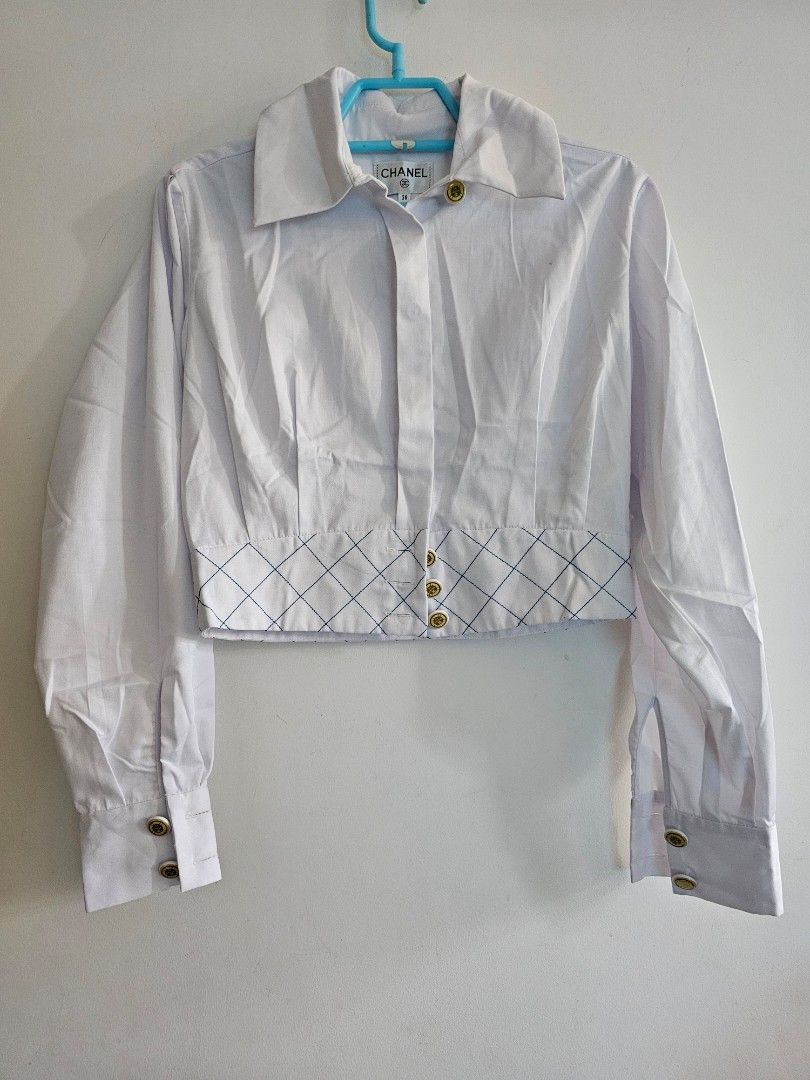 Chanel La Pausa Silk Cotton Crop Blouse Top (Category: Blouses) located in Singapore. Submitted by prelovedtoluvv (Listing ID 1437337595, Image 1). Description: - cutlabel Chanel cropped Top blouse - White color size36 - Quilted design on the front - Gold buttons with Chanel logo sopretty - Made in France NO Trades, Lowballers,Fussy NO Refund Return once sold .