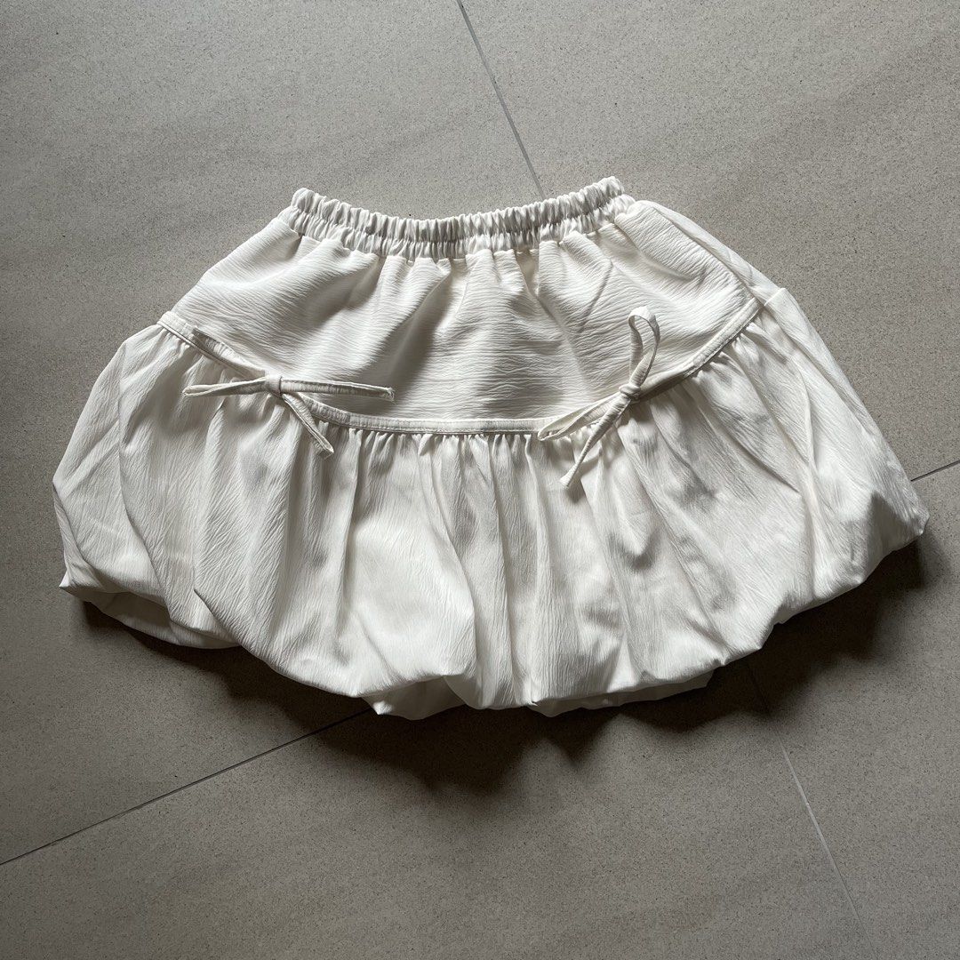 White Ribbon Bubble Skirt (Category: Skirts) located in Singapore. Submitted by skyscraper (Listing ID 1439557043, Image 2). Description: worn a few times freesized, fits XS-L from bangkok measurements: waist 9.5-16" length 12.5" details: - functional self-tie ribbon bow details at the front - elasticised waistband - no inner shorts - double lined, non-sheer - airy bubble silhouette.