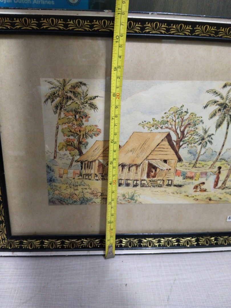 1950s Kampong Scenery Watercolour Painting of Tropical Village Scene (Category: Frames & Pictures) located in Singapore. Submitted by mypassionlisbon (Listing ID 1441154919, Image 4). Description: - Framed watercolour painting - kampong scene with stilt houses and palm trees - Figures in foreground - Artist signature: C.H. Soh - Frame: Black and gold decorative border - Dimensions: Approx. 19 inches x 15 inches.