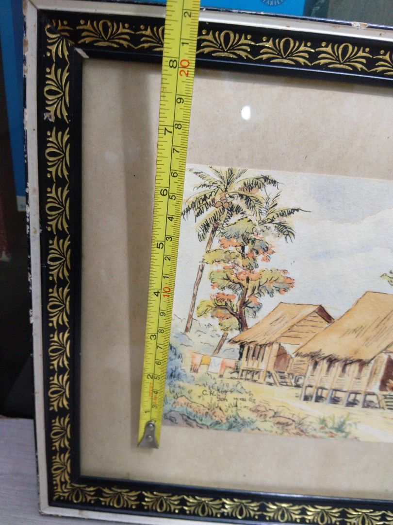 1950s Kampong Scenery Watercolour Painting of Tropical Village Scene (Category: Frames & Pictures) located in Singapore. Submitted by mypassionlisbon (Listing ID 1441154919, Image 5). Description: - Framed watercolour painting - kampong scene with stilt houses and palm trees - Figures in foreground - Artist signature: C.H. Soh - Frame: Black and gold decorative border - Dimensions: Approx. 19 inches x 15 inches.