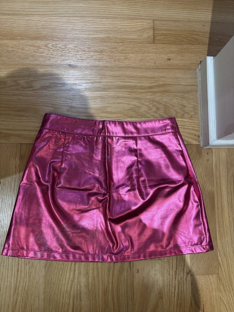 SHEIN Pink Metallic Mini Skirt M (Category: Skirts) located in Singapore. Submitted by sapphire_topaz (Listing ID 1436783968, Image 2). Description: - Pink metallic mini skirt - Front zipper - Two back pockets - Perfect for a bold look or night out - Some discoloration at the back but still ok, a bit of the worn look - Exchange with 3 box of tissue paper - Clementi MRT.