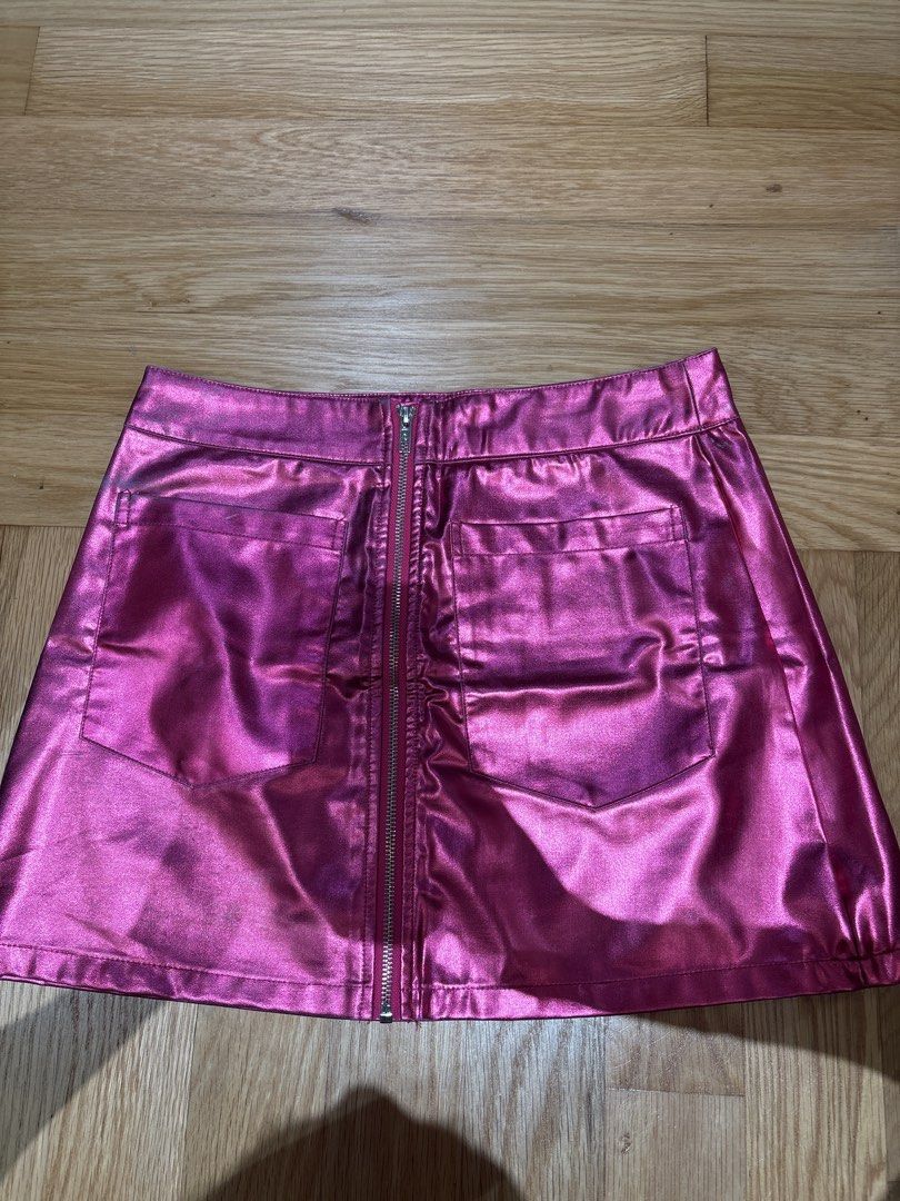 SHEIN Pink Metallic Mini Skirt M (Category: Skirts) located in Singapore. Submitted by sapphire_topaz (Listing ID 1436783968, Image 3). Description: - Pink metallic mini skirt - Front zipper - Two back pockets - Perfect for a bold look or night out - Some discoloration at the back but still ok, a bit of the worn look - Exchange with 3 box of tissue paper - Clementi MRT.