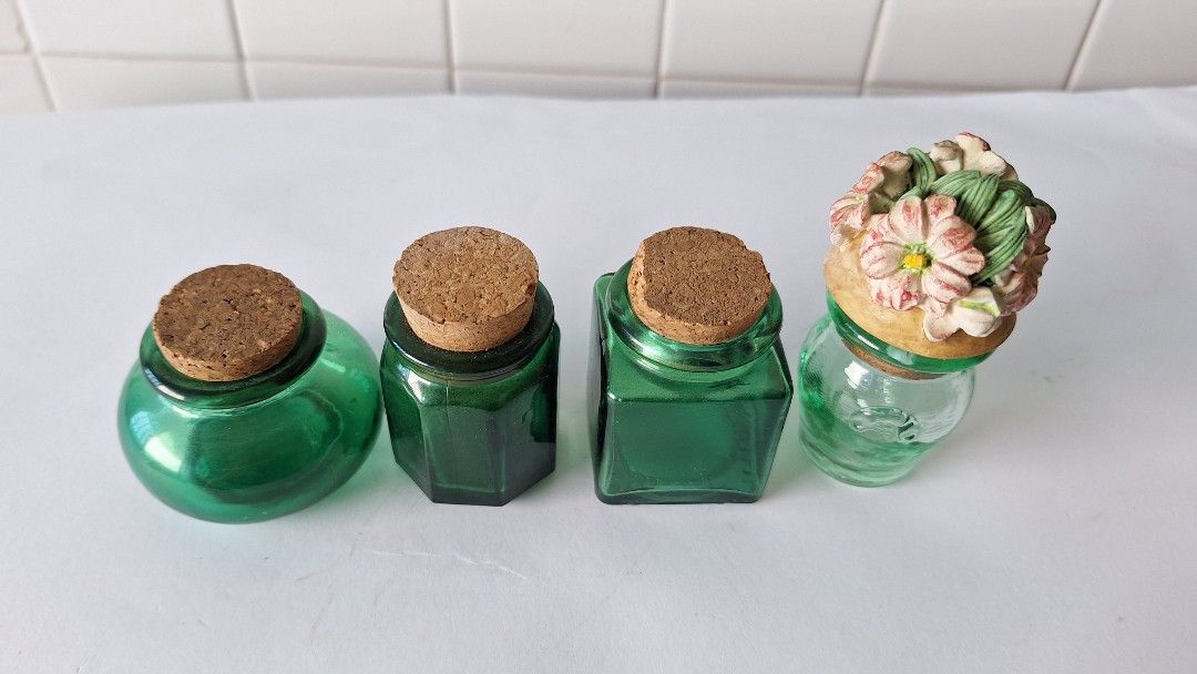 7 Mini Glass Bottles with Cork Stoppers (Category: Water Bottles & Tumblers) located in Singapore. Submitted by lg3210 (Listing ID 1443009604, Image 4). Description: - Set of 7 small green glass bottles. - Includes cork stoppers. - Variety of unique shapes. - 1 bottle features a decorative floral top. - Ideal for DIY crafts or home decoration. - No chips or cracks. All for $15.00 Cash payment & self-collection..