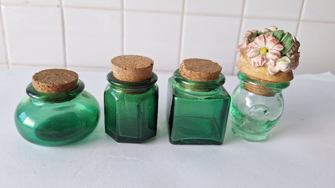 7 Mini Glass Bottles with Cork Stoppers (Category: Water Bottles & Tumblers) located in Singapore. Submitted by lg3210 (Listing ID 1443009604, Image 5). Description: - Set of 7 small green glass bottles. - Includes cork stoppers. - Variety of unique shapes. - 1 bottle features a decorative floral top. - Ideal for DIY crafts or home decoration. - No chips or cracks. All for $15.00 Cash payment & self-collection..