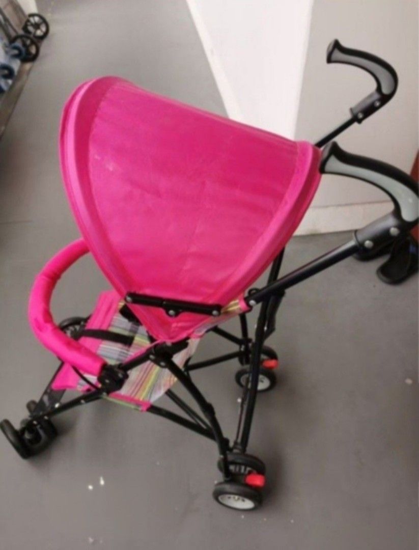 Pink Lightweight Baby Stroller (Category: Strollers) located in Singapore. Submitted by scllee (Listing ID 1443562936, Image 3). Description: - Adorable pink stroller - Comfy colorful striped seat - Folds compactly for easy storage - Built-in canopy for sun protection - Secure safety harness - Swivel wheels for effortless maneuverability - Ideal for daily walks and travel.