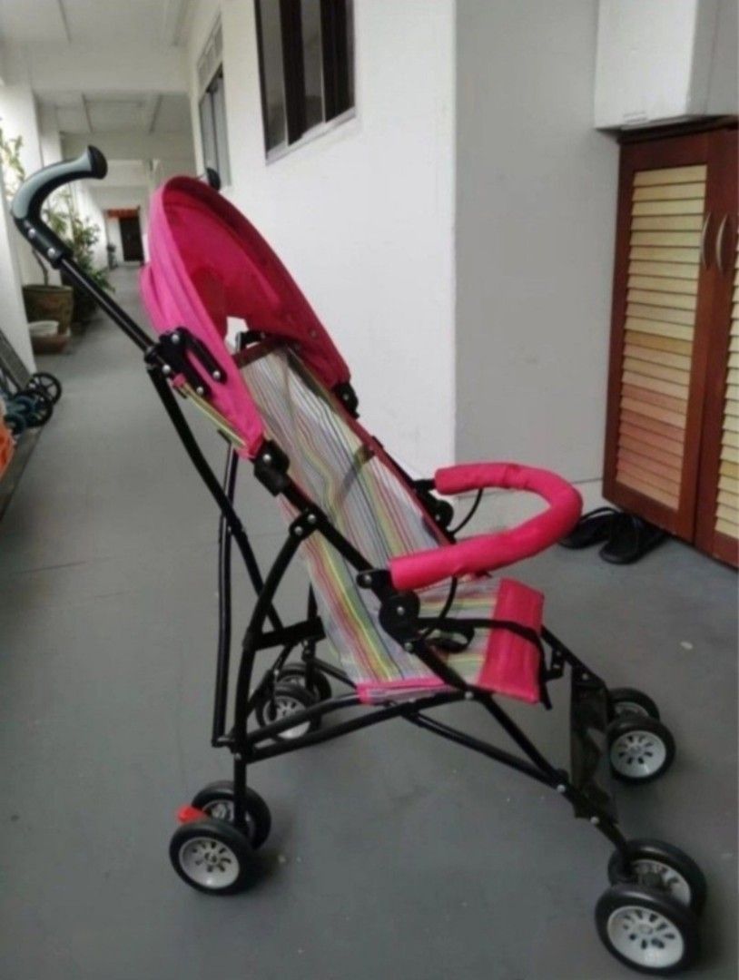 Pink Lightweight Baby Stroller (Category: Strollers) located in Singapore. Submitted by scllee (Listing ID 1443562936, Image 1). Description: - Adorable pink stroller - Comfy colorful striped seat - Folds compactly for easy storage - Built-in canopy for sun protection - Secure safety harness - Swivel wheels for effortless maneuverability - Ideal for daily walks and travel.