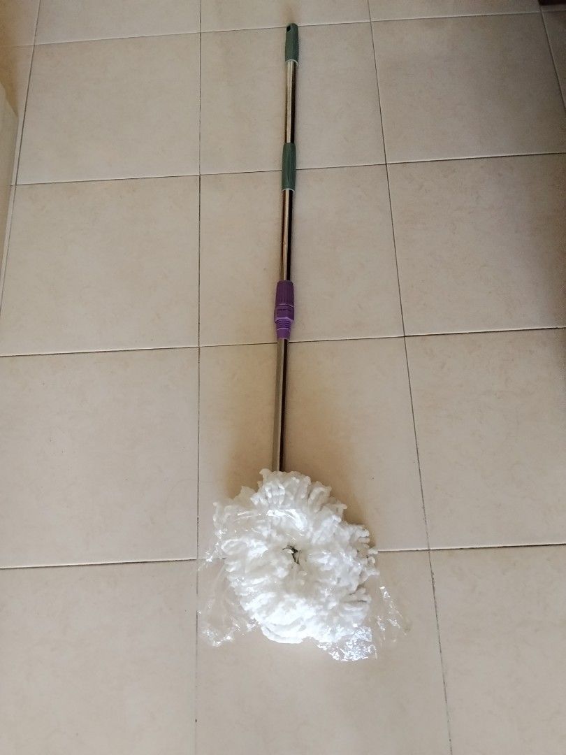 WTS: Spin Mop with Extendable Handle (Category: Cleaning Tools & Supplies) located in Singapore. Submitted by 3r.co (Listing ID 1446256460, Image 1). Description: - Extendable handle with silver, green, and purple accents - White, fluffy mop head - Ideal for cleaning all floor types - Simple to use and store - Achieve sparkling clean floors effortlessly.