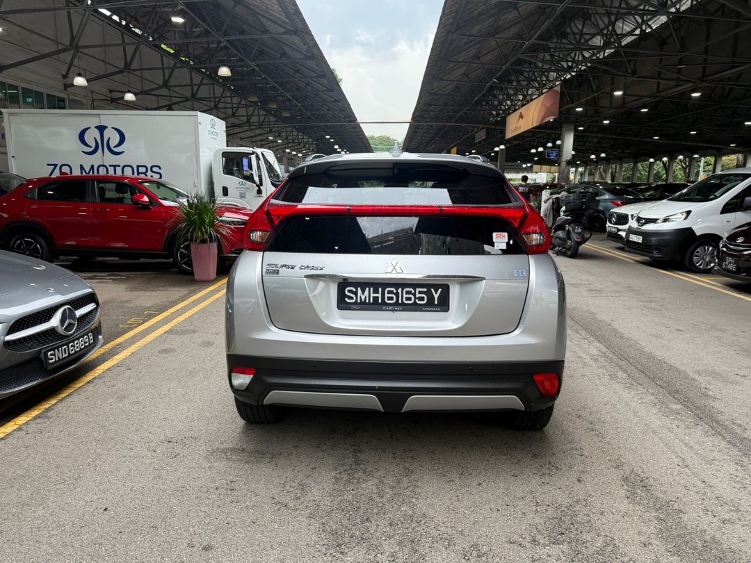 Mitsubishi Eclipse Cross 1.5T Classic (A) (Category: Used Cars) located in Singapore. Submitted by kyra-ktmotoring (Listing ID 1446567720, Image 4). Description: FULLY AGENT SERVICED UP TILL DATE ✅WEAR AND TEAR FULLY DONE UP ✅ENGINE AND GEARBOX WARRANTY COVERED TILL END OF COE ✅ 1.98% INTEREST RATE ✅HIGH LOAN APPROVAL RATE ✅ $0 DRIVEAWAY / FULL LOAN WELCOME Silver Mitsubishi Eclipse Cross. SUV with black rims. Spacious boot. Great for families or