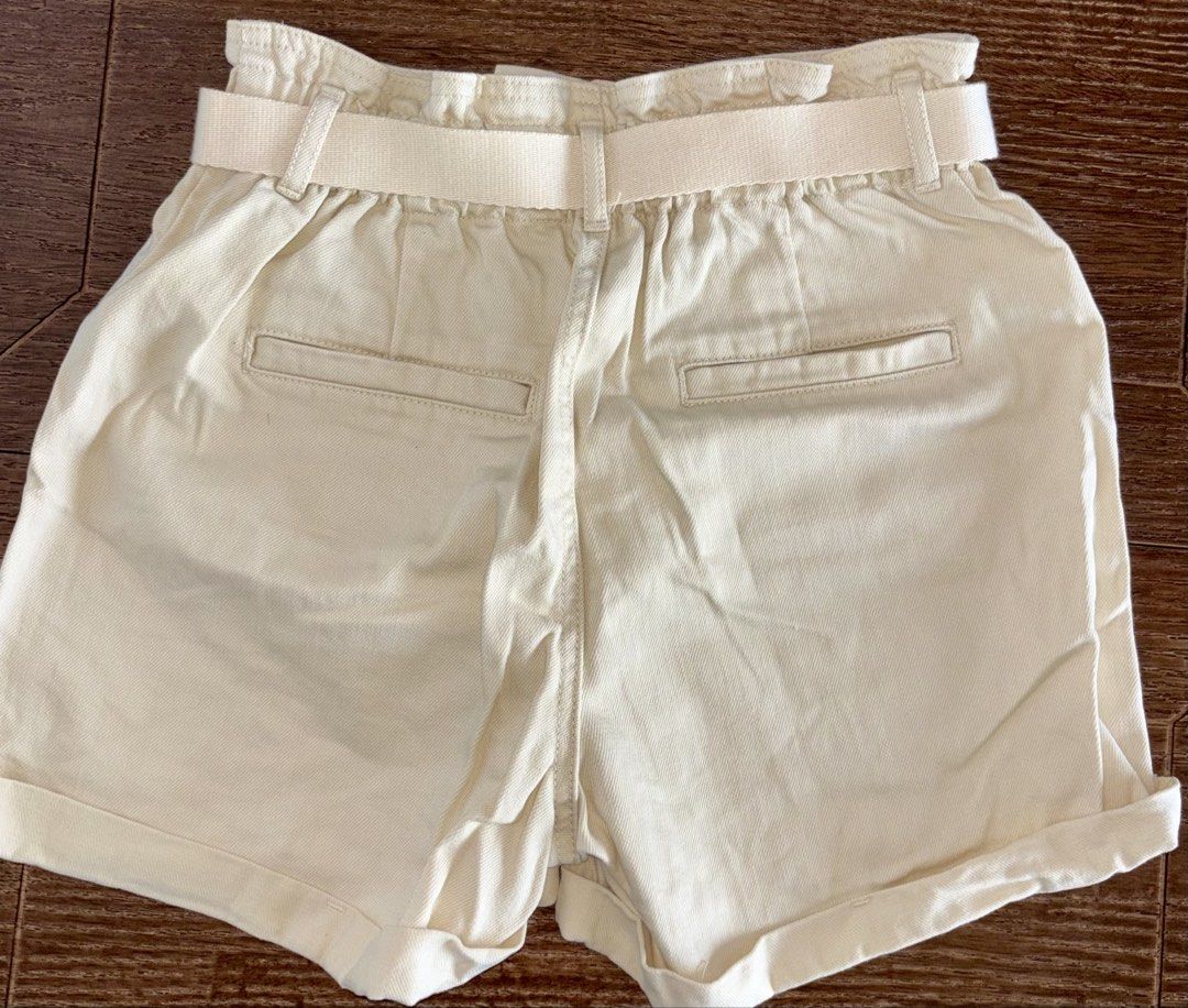 Cream Paperbag Waist Shorts with Belt (Category: Shorts) located in Singapore. Submitted by liuxue3918 (Listing ID 1441793373, Image 2). Description: - Stylish cream paperbag waist shorts - Brand: Rachel Zoe - Features: High waist, adjustable fabric belt with D-ring buckle, cuffed hems - Style: Chic casual look - Condition: Excellent.
