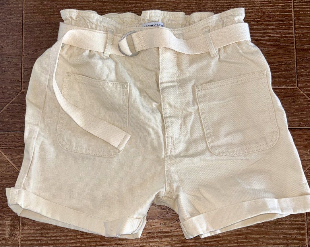 Cream Paperbag Waist Shorts with Belt (Category: Shorts) located in Singapore. Submitted by liuxue3918 (Listing ID 1441793373, Image 1). Description: - Stylish cream paperbag waist shorts - Brand: Rachel Zoe - Features: High waist, adjustable fabric belt with D-ring buckle, cuffed hems - Style: Chic casual look - Condition: Excellent.