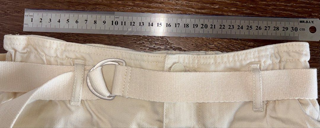 Cream Paperbag Waist Shorts with Belt (Category: Shorts) located in Singapore. Submitted by liuxue3918 (Listing ID 1441793373, Image 3). Description: - Stylish cream paperbag waist shorts - Brand: Rachel Zoe - Features: High waist, adjustable fabric belt with D-ring buckle, cuffed hems - Style: Chic casual look - Condition: Excellent.