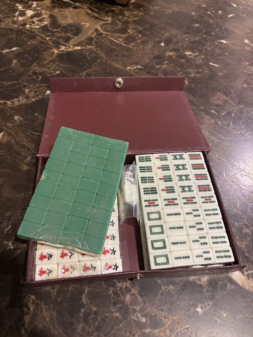 (Brand New and Sealed) Vintage mini Chinese Mahjong Set with Case (Category: Board Games & Puzzles) located in Singapore. Submitted by anna20_crystal (Listing ID 1447031703, Image 2). Description: - Complete mini Mahjong tiles -17mm x 11.5mm x2mm - Includes all tiles and dice - Deep red case with gold Chinese characters - Standard size and design tiles - Perfect for game nights.