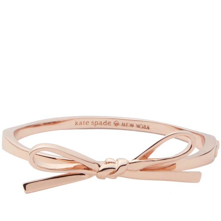 Kate Spade Rose Gold Bow Bangle Bracelet (Category: Bracelets) located in Singapore. Submitted by catchingclouds (Listing ID 1446928274, Image 1). Description: - Authentic Kate Spade bangle - Rose gold color - Cute bow detail - Engraved 'kate spade new york' inside - Comes with original tag - Never worn (brand new).