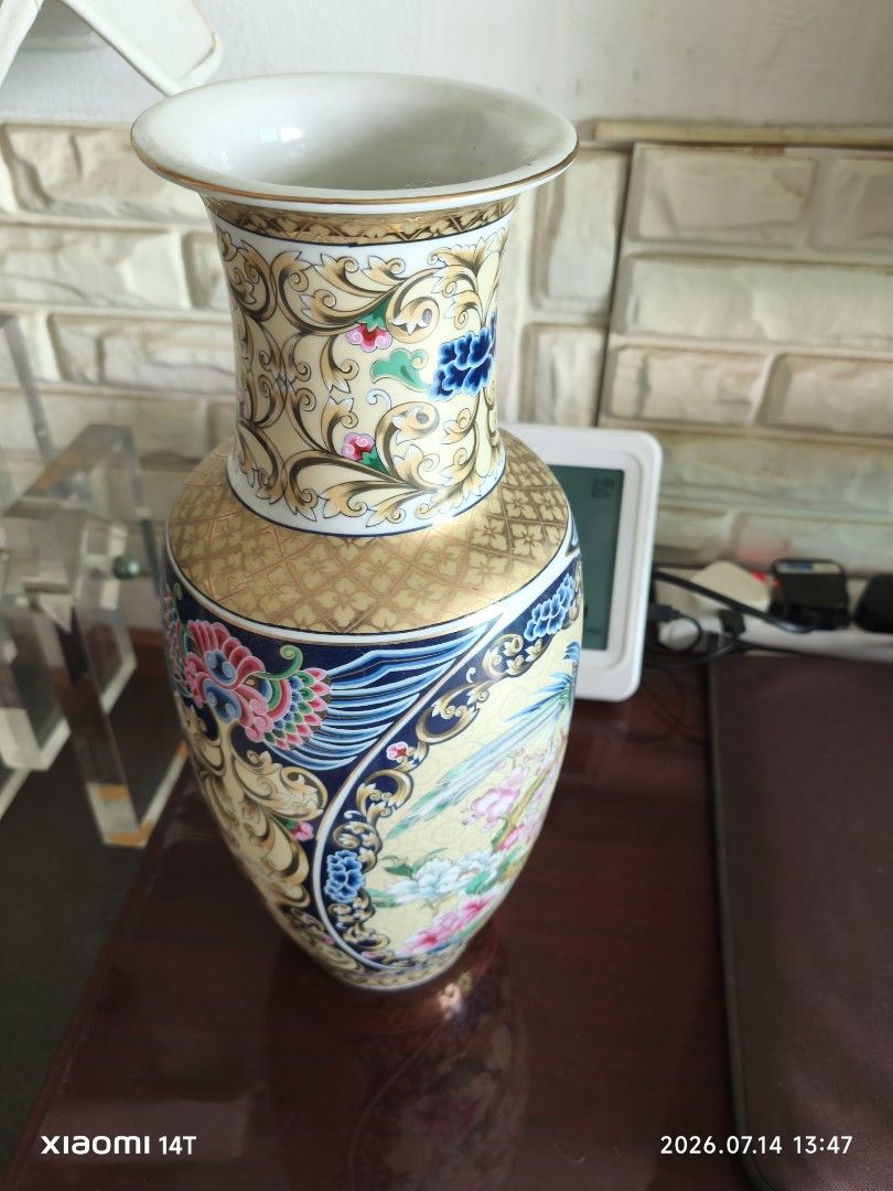 Vintage Porcelain Vase with Peacock and Floral Design (Category: Vases & Decorative Bowls) located in Singapore. Submitted by 823196 (Listing ID 1449586329, Image 5). Description: - Beautiful vintage porcelain vase - Intricate peacock and floral motifs in vibrant colors - Textured gold pattern on neck and base - Approx. 36cm height tall - Adds a classic touch to home decor - Ideal for flowers or as a decorative piece Widest width approx 15cm with