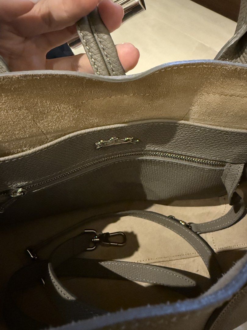 Longchamp Roseau Top Handle Bag M in Grey Leather (Category: Bags & Wallets) located in Singapore. Submitted by chikichiki96 (Listing ID 1449902233, Image 4). Description: - Brand: Longchamp - authentic 100% - Color: Grey - Dimension: 30 cm (Length) x 23.5 cm (Height) x 12 cm (Width) - Material: Leather - Features: Internal zip pocket, detachable strap - Includes: Dust bag - Ideal for: Everyday use, travel - Pick up: TPY/ Braddell mrt.