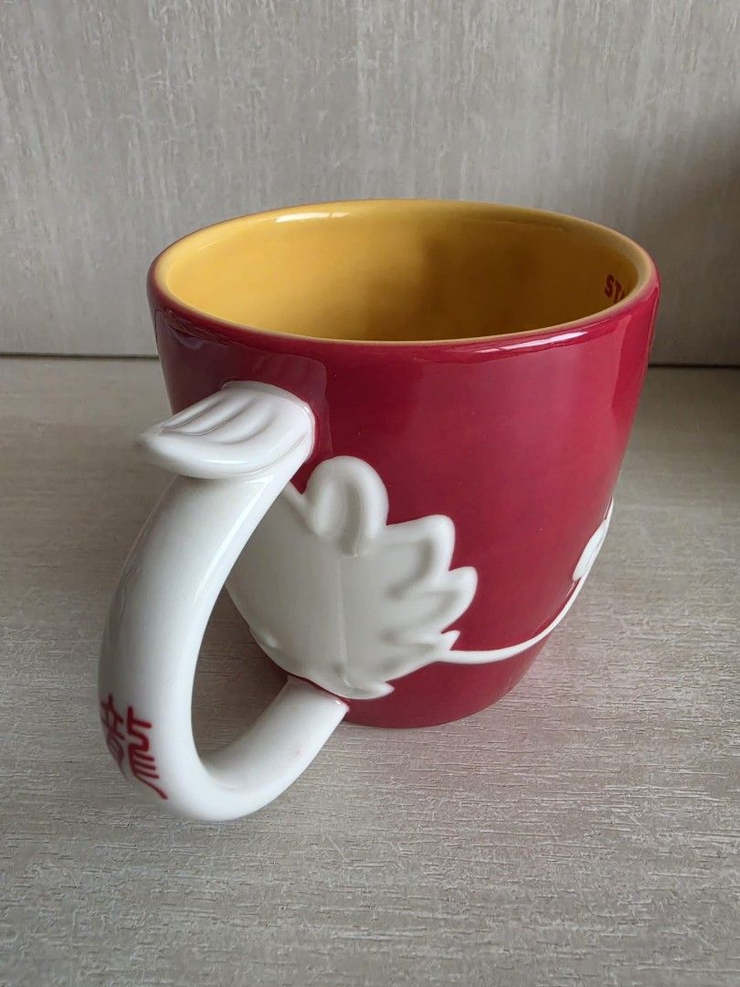 Starbucks Red Dragon Mug with Box (Category: Coffee & Tea Tableware) located in Singapore. Submitted by vl2768 (Listing ID 1449977010, Image 4). Description: - Red Starbucks mug - Features a white dragon design - Chinese character '龍' (dragon) on the handle - Comes with original Starbucks box - Ideal for collectors or dragon enthusiasts - Unique and eye-catching design.