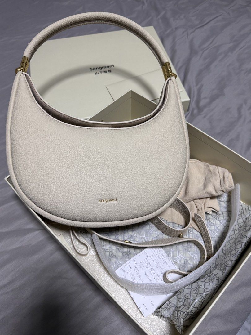 Songmont Luna Bag Cream Pebble Leather (Category: Shoulder Bags) located in Singapore. Submitted by jenray (Listing ID 1452475391, Image 1). Description: - Cream colored Songmont Luna bag - Pebble leather texture - Gold hardware details - Includes dust bag, box, shoulder strap and receipt - can be carried on shoulder and cross body. Can also be handheld - if you know bags, you would know this one - bought from Shanghai boutique .