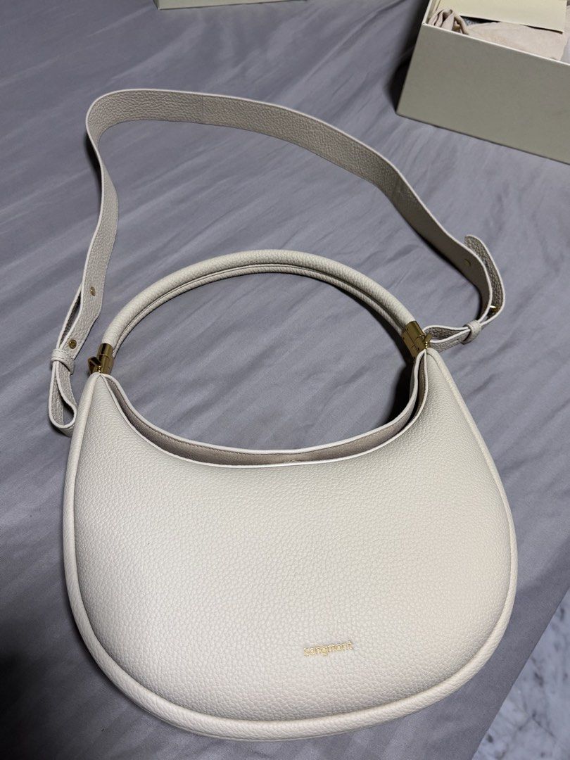 Songmont Luna Bag Cream Pebble Leather (Category: Shoulder Bags) located in Singapore. Submitted by jenray (Listing ID 1452475391, Image 3). Description: - Cream colored Songmont Luna bag - Pebble leather texture - Gold hardware details - Includes dust bag, box, shoulder strap and receipt - can be carried on shoulder and cross body. Can also be handheld - if you know bags, you would know this one - bought from Shanghai boutique .