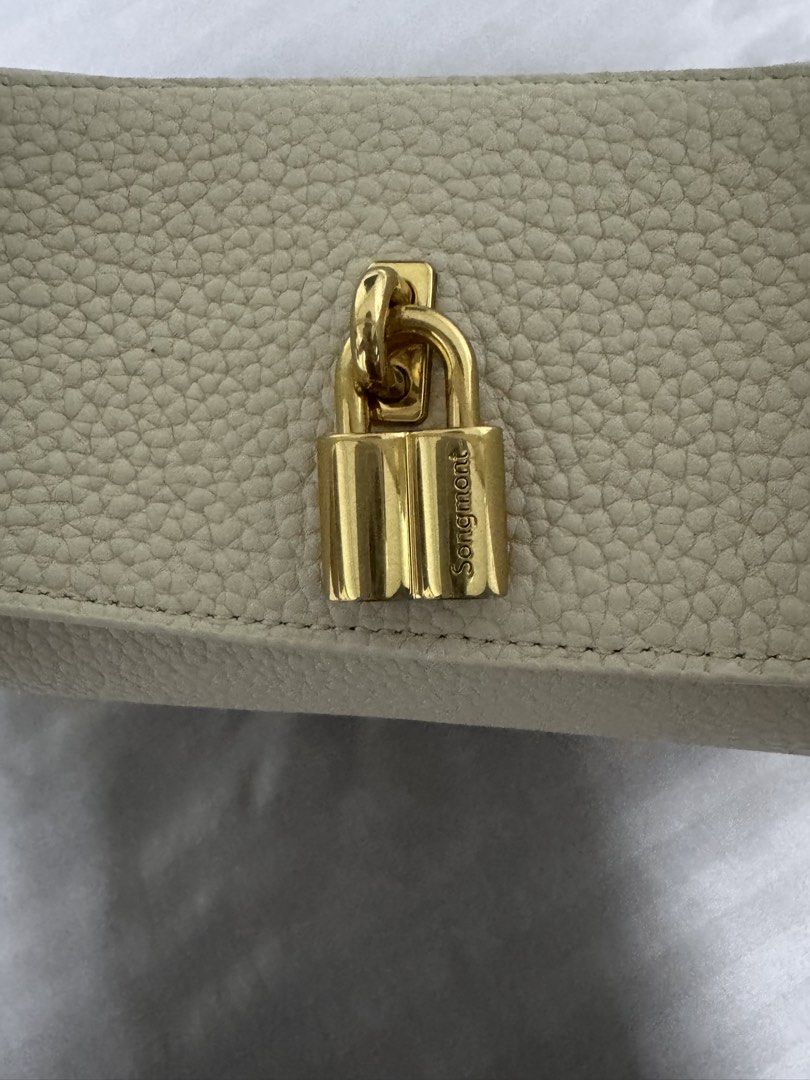 Songmont Luna Bag Cream Pebble Leather (Category: Shoulder Bags) located in Singapore. Submitted by jenray (Listing ID 1452475391, Image 5). Description: - Cream colored Songmont Luna bag - Pebble leather texture - Gold hardware details - Includes dust bag, box, shoulder strap and receipt - can be carried on shoulder and cross body. Can also be handheld - if you know bags, you would know this one - bought from Shanghai boutique .