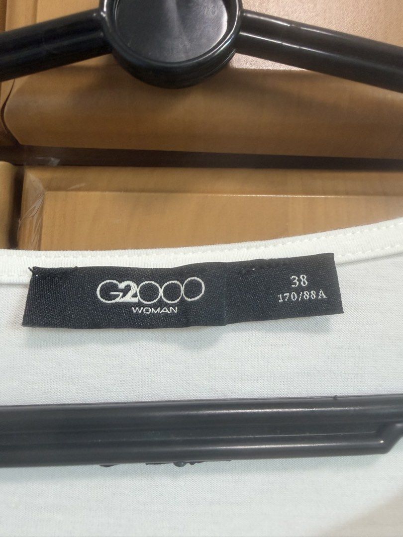 G2000 Woman White Asymmetrical Pleated T-shirt Size 38 (Category: Shirts) located in Singapore. Submitted by tink_ez (Listing ID 1447702534, Image 2). Description: - White G2000 T-shirt - Size 38 - Asymmetrical hem with pleats on one side - Short sleeves - Comfortable fabric - Ideal for casual wear or layering.