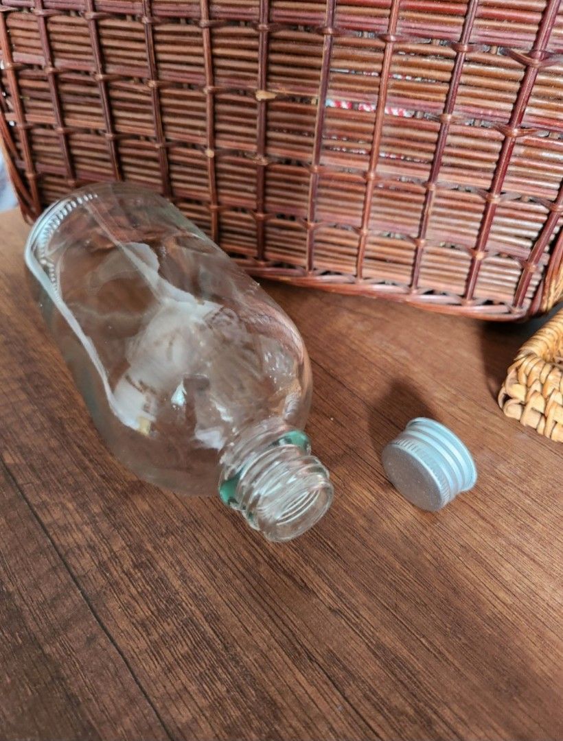 Clear Glass Bottles (280ml) with Silver Caps (Category: Water Bottles & Tumblers) located in Singapore. Submitted by sjliebtcraft (Listing ID 1447888364, Image 4). Description: - Clearing brand new 280ml glass bottles from warehouse - Include silver screw-on caps - Versatile for storing liquids, DIY projects, or as small vases - Bottles are empty and clean - Rounded shape with a flat base.