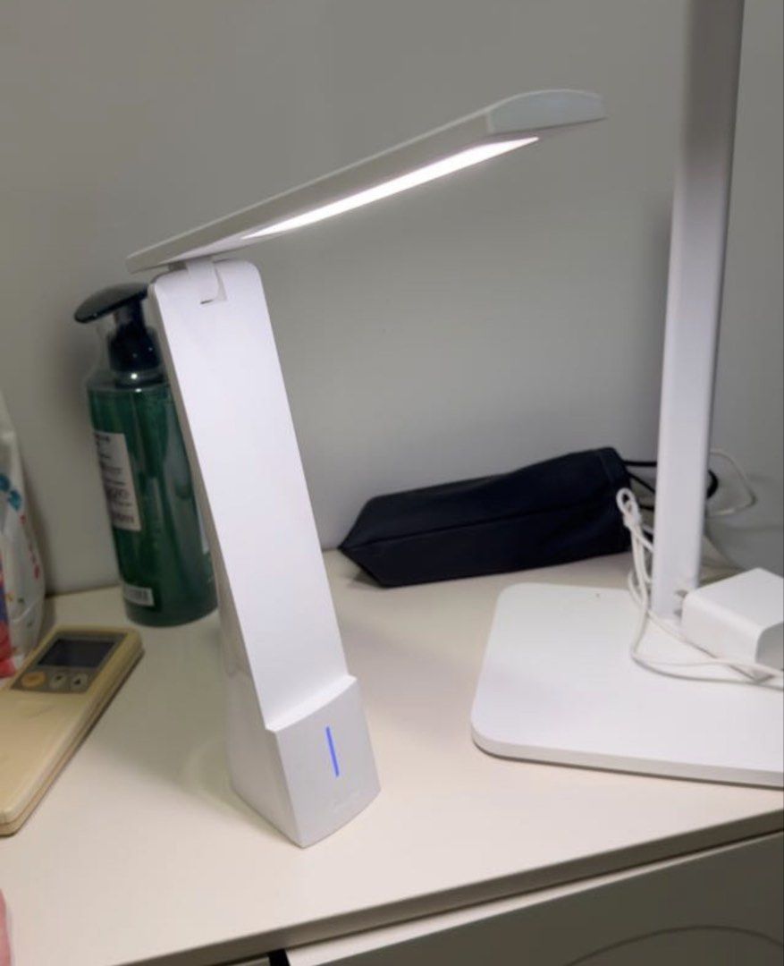 White LED Desk Lamp with Adjustable Arm (Category: Lighting) located in Singapore. Submitted by bubududucollection (Listing ID 1448202204, Image 2). Description: - Bright white LED light - Adjustable arm and head for flexible positioning - Modern, simple design - Blue indicator light on the base - Ideal for studying and working.