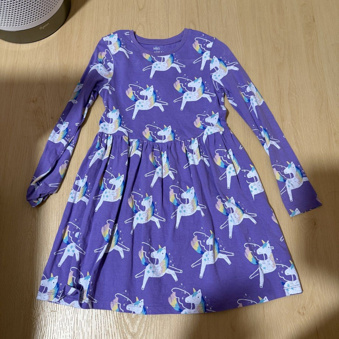 (4 for $10) Marks & Spencer Bundle of 4 Girls' Dresses - Unicorn, Dinosaur, Fruit, Ice Cream (6-7 years) (Category: Babies & Kids Fashion) located in Singapore. Submitted by robinsparkless (Listing ID 1454842940, Image 2). Description: - Set of 4 adorable dresses for girls. - Designs include: Purple Unicorn, Pink Ice Cream, Cream Dinosaur, Purple Fruit. - Sleeve types: Unicorn & Dinosaur (long sleeve), Ice Cream & Fruit (short sleeve). - Ideal fo
