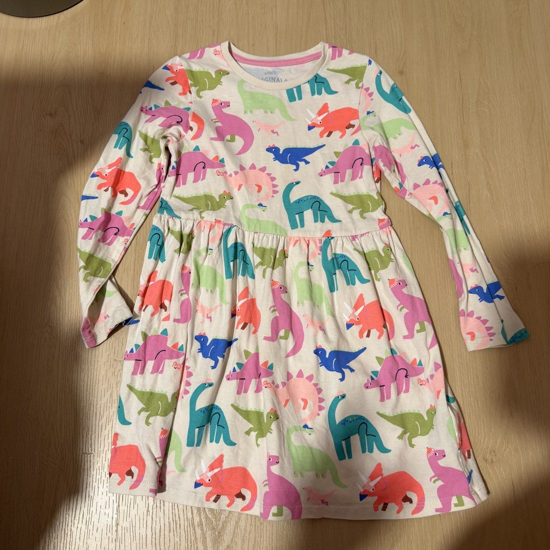 (4 for $10) Marks & Spencer Bundle of 4 Girls' Dresses - Unicorn, Dinosaur, Fruit, Ice Cream (6-7 years) (Category: Babies & Kids Fashion) located in Singapore. Submitted by robinsparkless (Listing ID 1454842940, Image 4). Description: - Set of 4 adorable dresses for girls. - Designs include: Purple Unicorn, Pink Ice Cream, Cream Dinosaur, Purple Fruit. - Sleeve types: Unicorn & Dinosaur (long sleeve), Ice Cream & Fruit (short sleeve). - Ideal fo