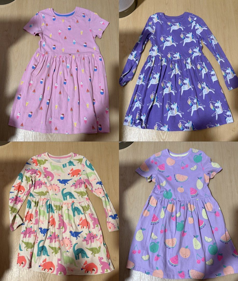 (4 for $10) Marks & Spencer Bundle of 4 Girls' Dresses - Unicorn, Dinosaur, Fruit, Ice Cream (6-7 years) (Category: Babies & Kids Fashion) located in Singapore. Submitted by robinsparkless (Listing ID 1454842940, Image 1). Description: - Set of 4 adorable dresses for girls. - Designs include: Purple Unicorn, Pink Ice Cream, Cream Dinosaur, Purple Fruit. - Sleeve types: Unicorn & Dinosaur (long sleeve), Ice Cream & Fruit (short sleeve). - Ideal fo