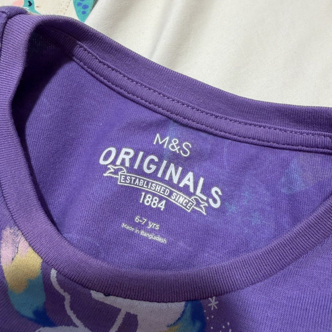 (4 for $10) Marks & Spencer Bundle of 4 Girls' Dresses - Unicorn, Dinosaur, Fruit, Ice Cream (6-7 years) (Category: Babies & Kids Fashion) located in Singapore. Submitted by robinsparkless (Listing ID 1454842940, Image 6). Description: - Set of 4 adorable dresses for girls. - Designs include: Purple Unicorn, Pink Ice Cream, Cream Dinosaur, Purple Fruit. - Sleeve types: Unicorn & Dinosaur (long sleeve), Ice Cream & Fruit (short sleeve). - Ideal fo