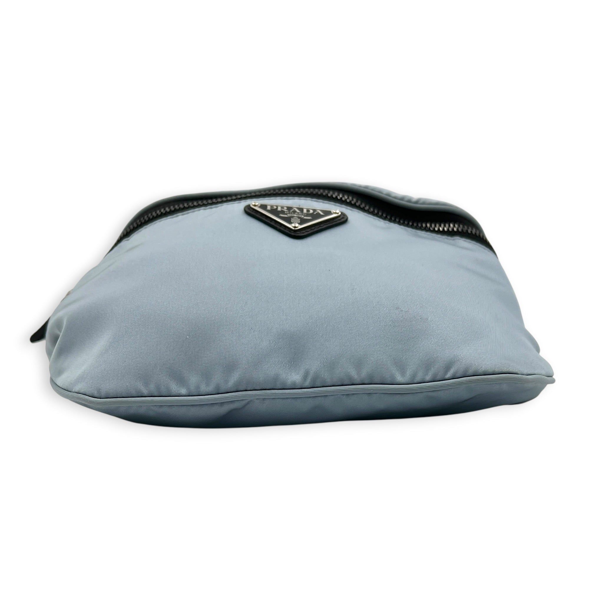 Prada Logo Belt Bag Blue in Nylon, Silver hardware (Category: Bags & Wallets) located in Singapore. Submitted by carousellluxury (Listing ID 1433830147, Image 5). Description: SKU C2604-011342AA Material Nylon Color Blue Hardware Silver Strap Included, non-detachable Dimension (L)20cm x (H)16cm x (W)1cm Accessories Dust Bag, Series 250 Circa Est NA Microchipped FALSE Condition - Surface: In very good condition overall - Bottom Edge / Base / Bagfe