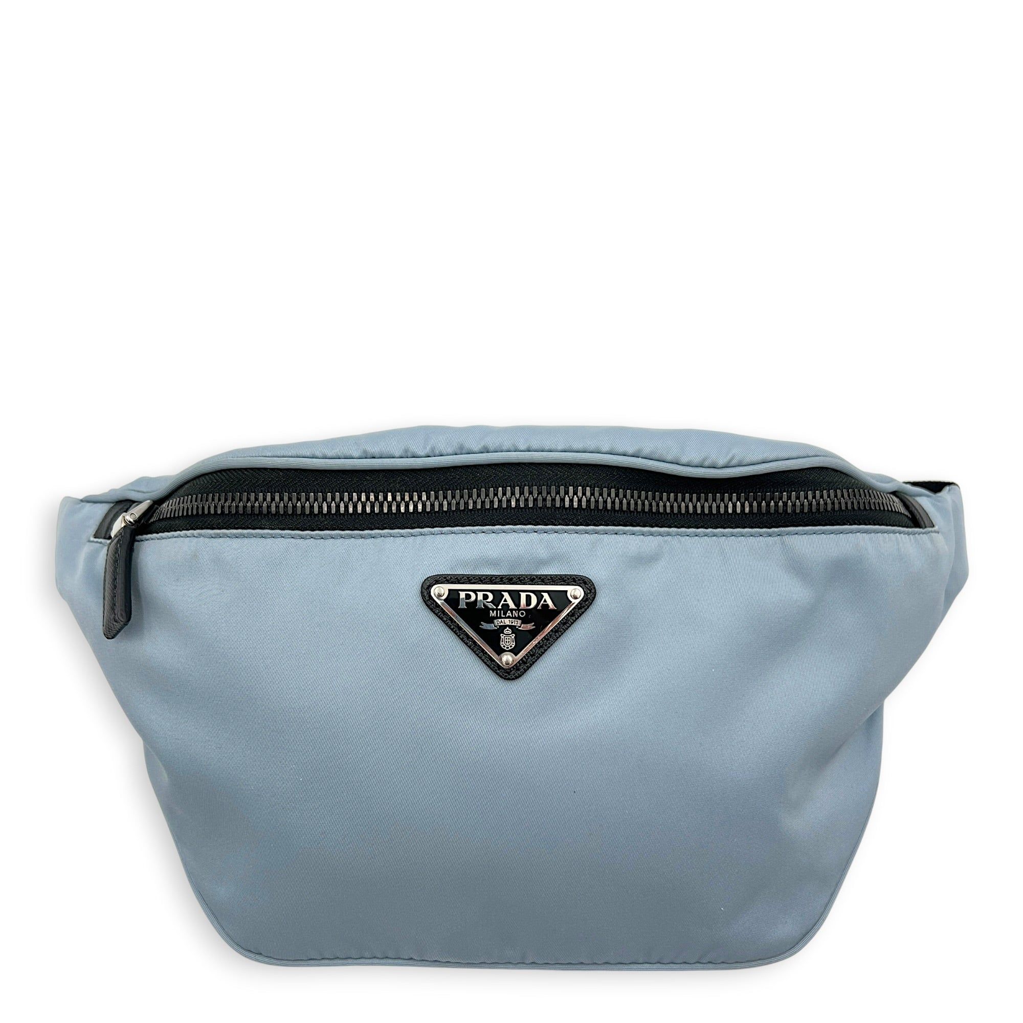 Prada Logo Belt Bag Blue in Nylon, Silver hardware (Category: Bags & Wallets) located in Singapore. Submitted by carousellluxury (Listing ID 1433830147, Image 1). Description: SKU C2604-011342AA Material Nylon Color Blue Hardware Silver Strap Included, non-detachable Dimension (L)20cm x (H)16cm x (W)1cm Accessories Dust Bag, Series 250 Circa Est NA Microchipped FALSE Condition - Surface: In very good condition overall - Bottom Edge / Base / Bagfe