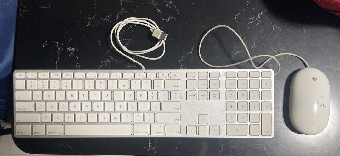Apple Wired Keyboard and Mouse Set (Category: Computer Keyboard) located in Singapore. Submitted by blackedoutcircle (Listing ID 1455584846, Image 1). Description: - Classic Apple wired keyboard and mouse set - White color - USB connectivity - Full-size keyboard with numeric keypad - Iconic Apple mouse design - Tested and confirmed working - Perfect for Mac users seeking a reliable setup.