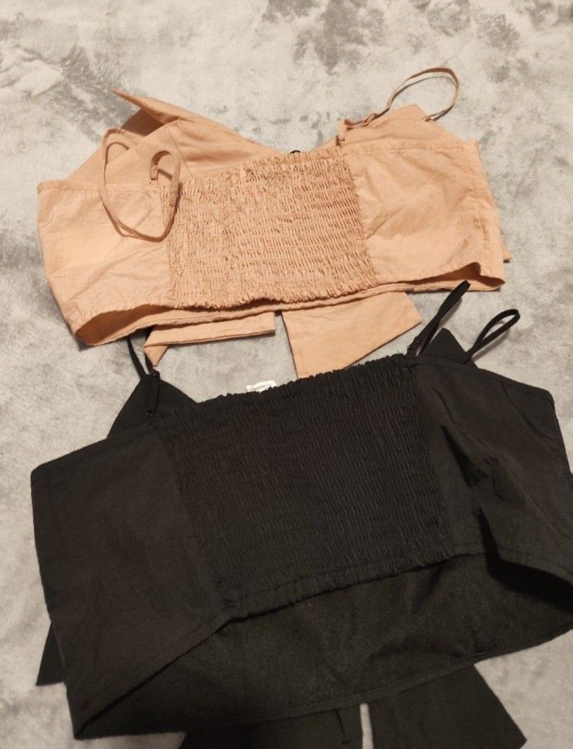 H&M Divided Smocked bow Crop Tops (2 Colors) (Category: Sleeveless) located in Singapore. Submitted by imrudelikethis (Listing ID 1455928868, Image 2). Description: - H&M Divided smocked crop tops - Colors: Black and Light Peach - Features adjustable spaghetti straps - Cute bow detail at the front - Smocked back for a snug and comfortable fit - Perfect for casual wear or dressing up.