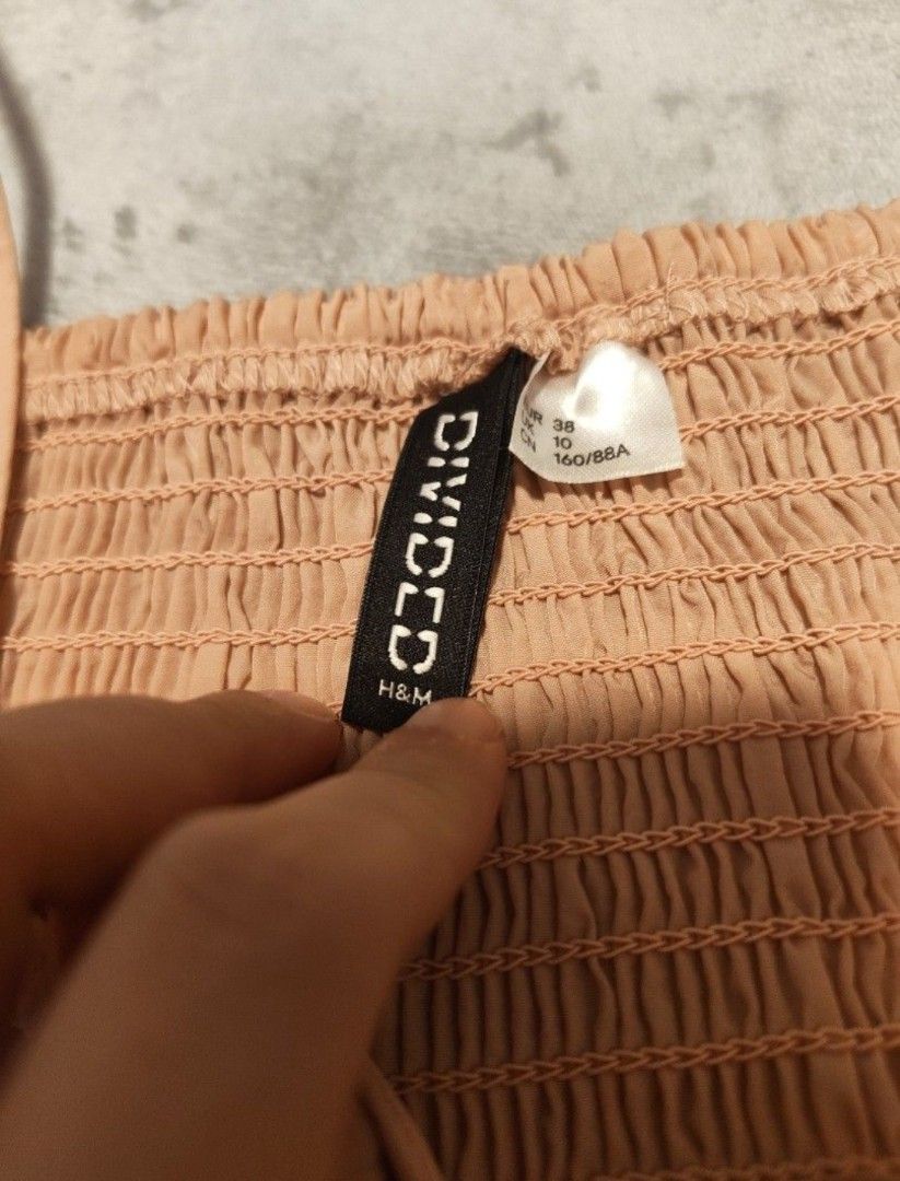 H&M Divided Smocked bow Crop Tops (2 Colors) (Category: Sleeveless) located in Singapore. Submitted by imrudelikethis (Listing ID 1455928868, Image 4). Description: - H&M Divided smocked crop tops - Colors: Black and Light Peach - Features adjustable spaghetti straps - Cute bow detail at the front - Smocked back for a snug and comfortable fit - Perfect for casual wear or dressing up.