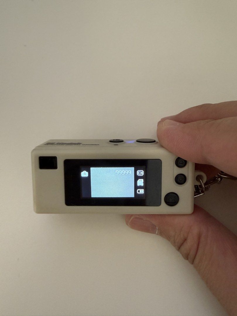 Kodak Charmera Keychain Digital Camera (Category: Cameras) located in Singapore. Submitted by annehillary (Listing ID 1455921365, Image 3). Description: - Cute Kodak Charmera keychain camera - Small digital camera with keychain attachment - Features a small screen and operational buttons - Switch between photo and video modes - Capable of storing many photos - A fun and unique gadget.